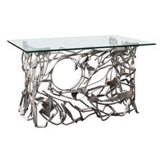 a glass table topped with metal items on top of a white background and a silver frame