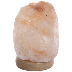 a large white rock sitting on top of a wooden stand