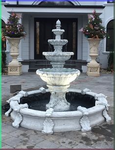 a large white water fountain sitting in front of a building