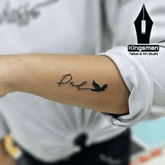 a person with a tattoo on their arm that reads, dru and has two birds flying around it