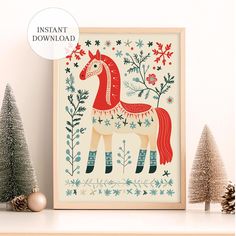 a christmas card with a horse on it next to two small trees and pine cones