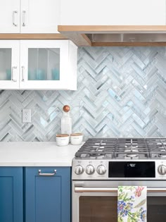 a stove top oven sitting inside of a kitchen next to white cupboards and cabinets