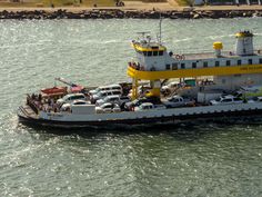 a ferry boat with cars on it in the water