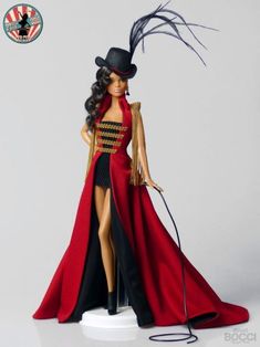 a barbie doll wearing a red dress and black hat with feathered tail, standing on a white base