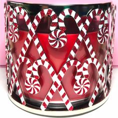 a red and white candy cane candle holder