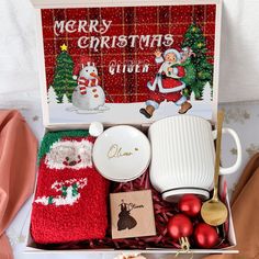 a christmas gift box filled with dishes, mugs and other holiday decorating items