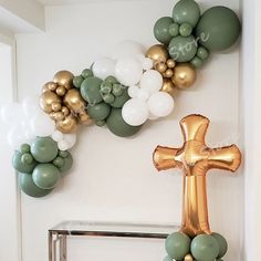 a cross and balloons are hanging on the wall