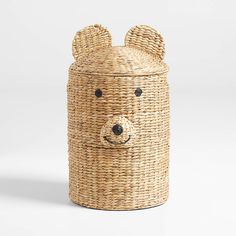 a wicker basket with a bear face on the front and sides, made out of woven material