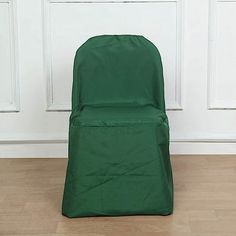 a green chair sitting on top of a hard wood floor