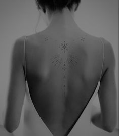 the back of a woman's neck with stars on it