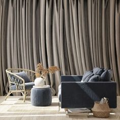 a living room with grey curtains and blue furniture