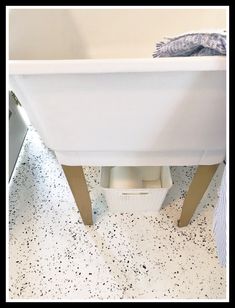 a white bath tub sitting on top of a bathroom floor