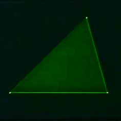 an image of a green triangle in the dark