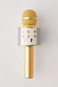 a gold and silver microphone on a white background