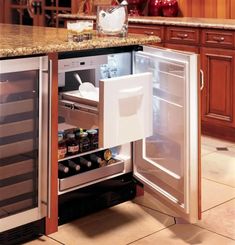 an open refrigerator in a kitchen next to a counter