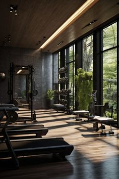 an empty gym with rows of benches and exercise equipment in front of large glass windows