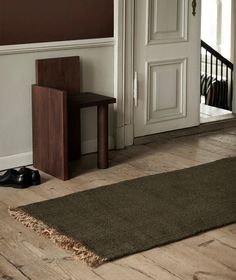 a brown rug sitting on top of a hard wood floor