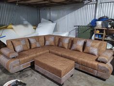 a large sectional couch sitting inside of a garage