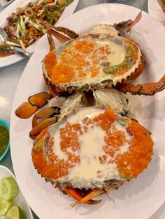 three crab legs covered in white sauce and garnishes