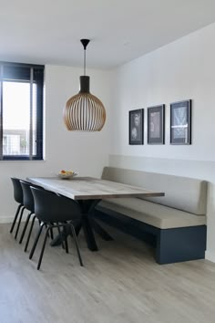 a dining room table with four chairs and a bench