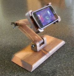 a wooden phone holder on top of a counter