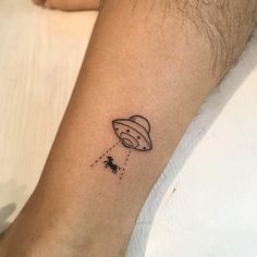 a small tattoo on the arm of a person with an saturn balloon in the sky