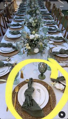 the table is set with plates and place settings