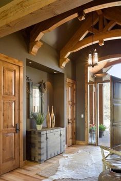 a large entry way with wooden doors and an arched doorway that leads to another room