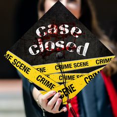 a woman holding up a black and yellow graduation cap with the words class closed on it