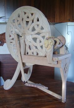 a chair made out of wood with an intricate design on it's back legs