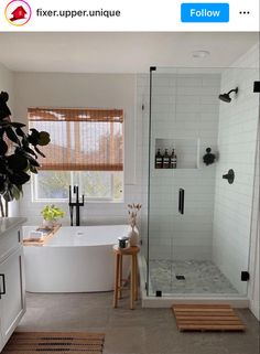 a bathroom with a tub, shower and rugs