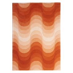 an orange and white area rug with wavy waves on the top, in front of a white background