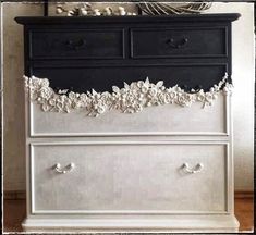 an old dresser is painted black and white