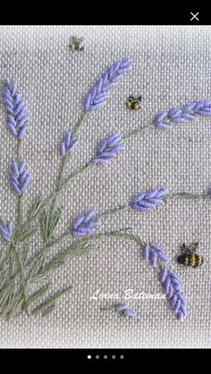 some lavender flowers and bees on a white cloth