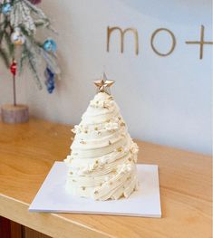 a white frosted christmas tree sitting on top of a table