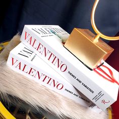 three books stacked on top of each other in front of a gold ring and black background