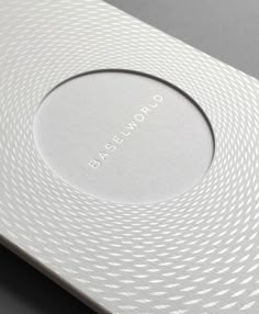 the back side of a white box on a gray surface with an inscription in it