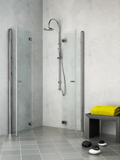 a bathroom with a yellow towel on the floor next to a stand up shower stall