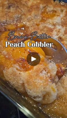 peach cobbler cooking in the oven with a spoon