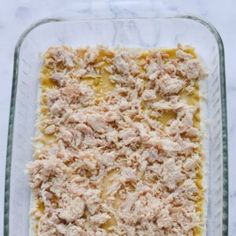 an uncooked casserole dish with cheese and meat toppings on top