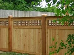 a wooden fence in the middle of a yard