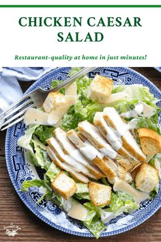 chicken caesar salad on a blue and white plate