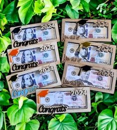 five different bills sitting on top of some green leaves in front of a bush with the words coronas printed on them