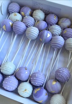 purple and white cake pops in a box