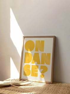 a framed poster sitting on top of a wooden table