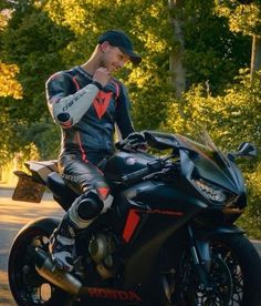 a man sitting on top of a black motorcycle