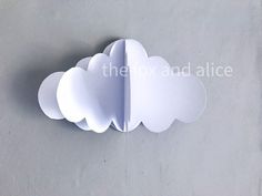 a paper cloud hanging from the side of a wall