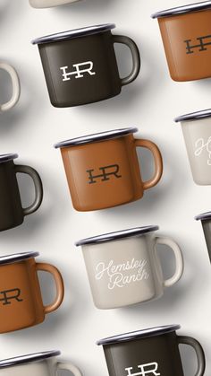 several coffee cups with the letters h and r on them are lined up in rows