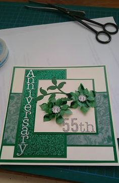 a close up of a card on a table with scissors and some other crafting supplies