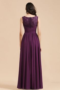 a woman in a long purple dress with lace detailing on the neck and back, looking down